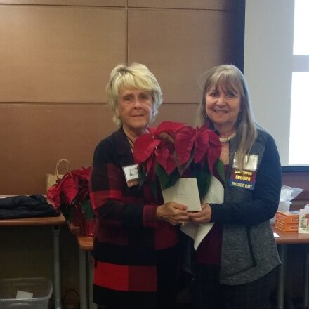 Carol, on the left, receives recognition for her 50 years as an Academy member.